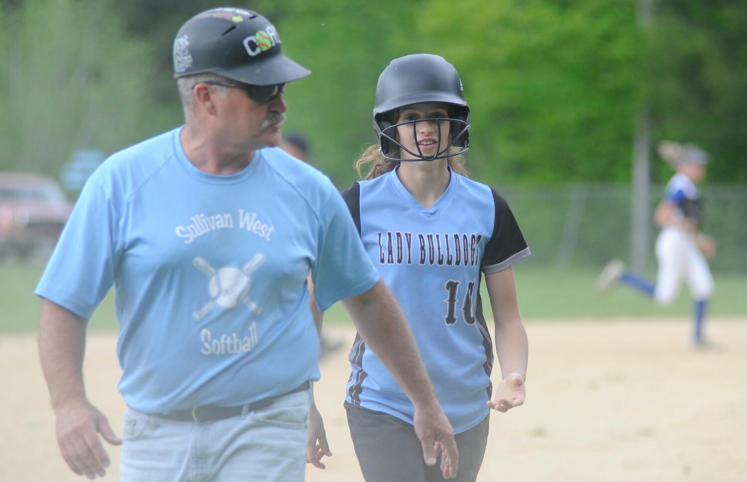 Coach and player. Sullivan West’s Anthony Durkin, veteran softball coach, foreground; and Gracyn Halloran.